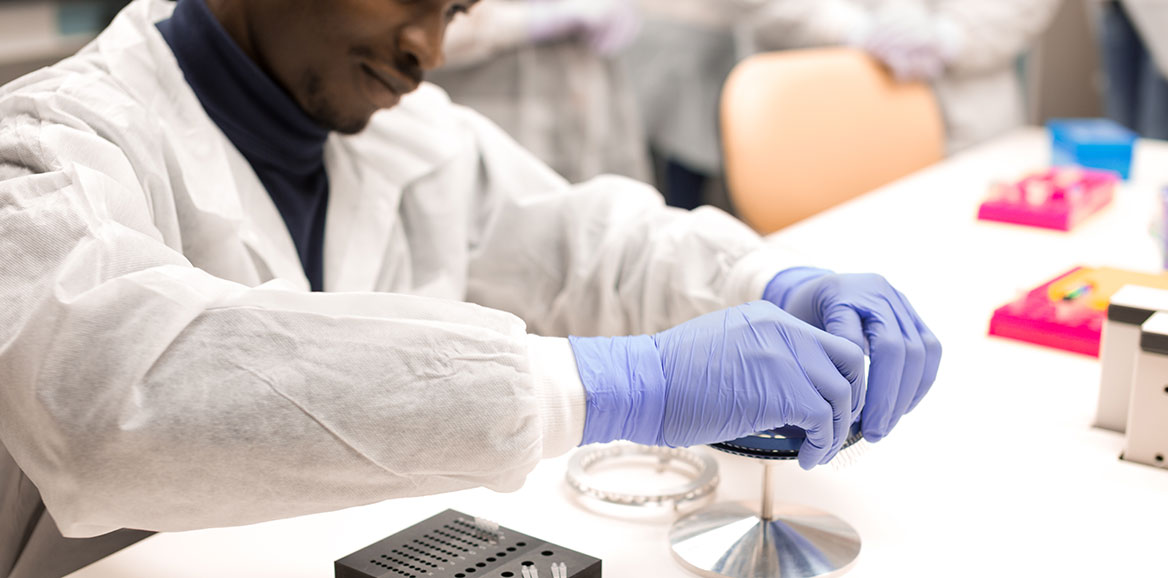 A Molecular Pathology student works with an instrument in the lab.