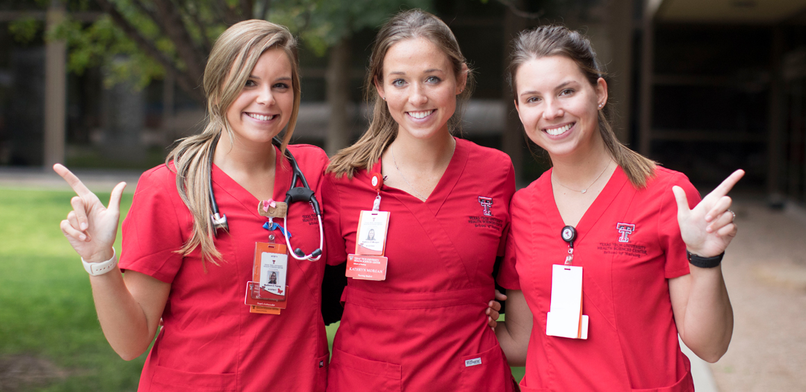 TTUHSC Nursing students standing in courtyard and showing school spirit.